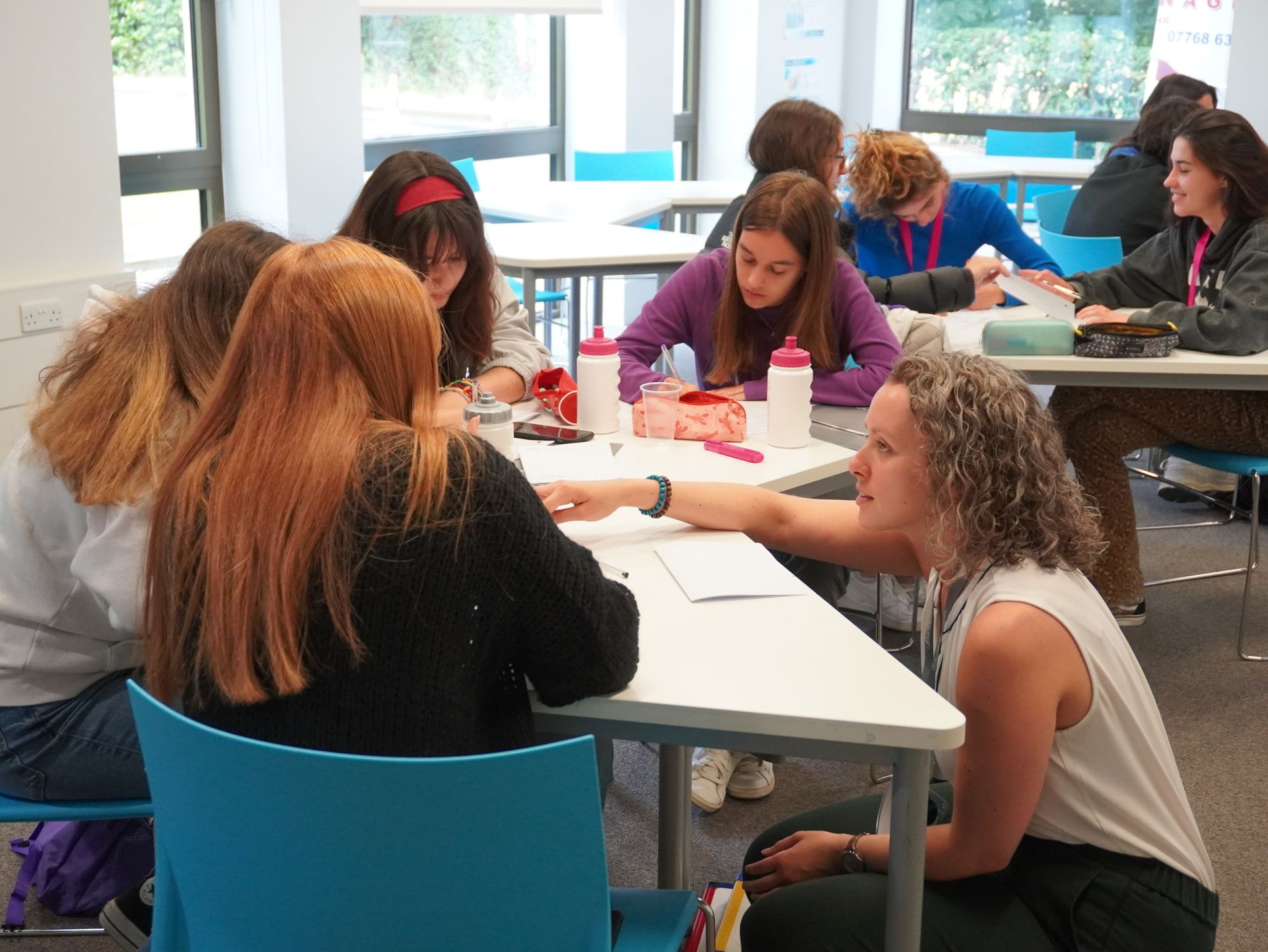 Image of teacher working with some students