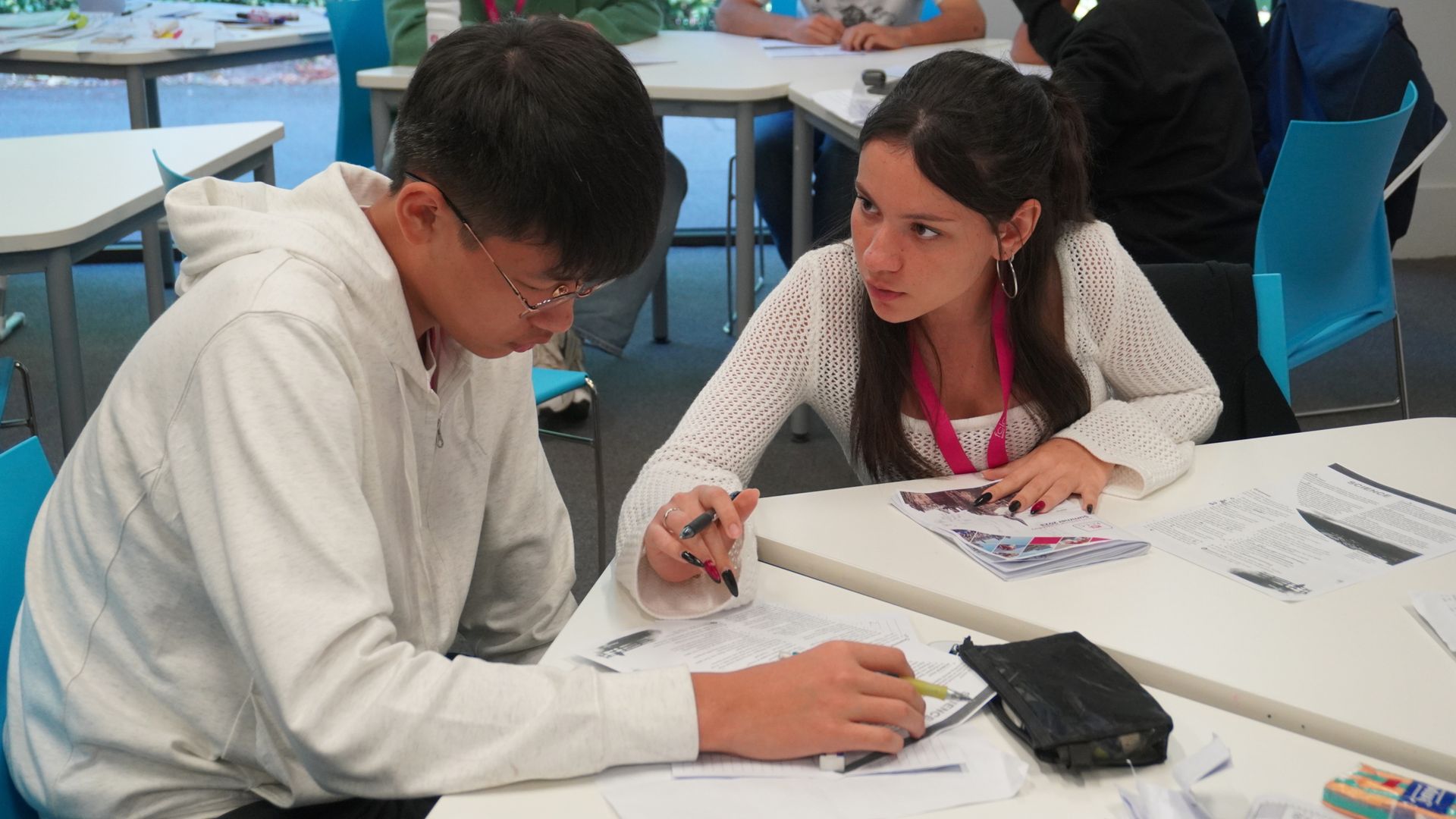 Image of two students working on something in class