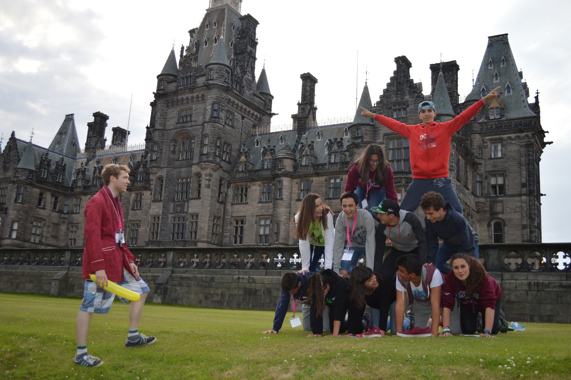 Students doing a human pyramid outside the front of the main building